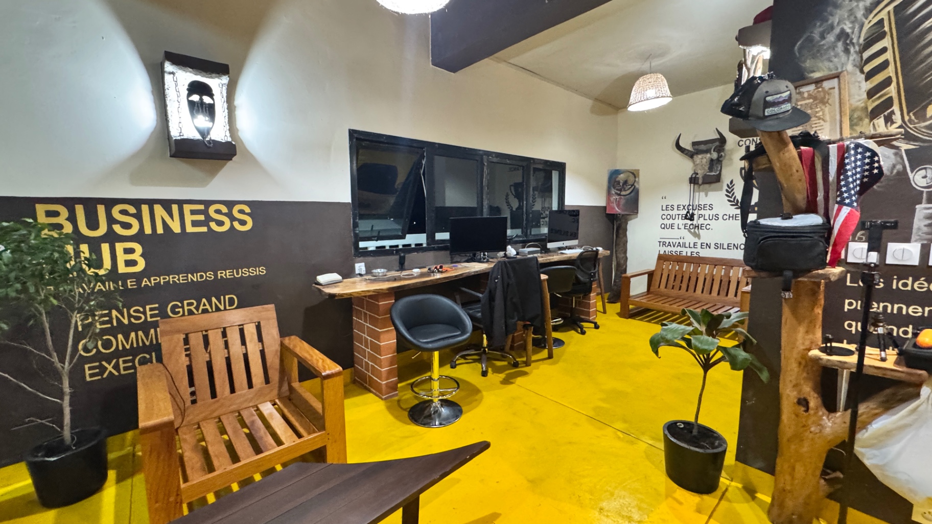 Coworking corner with wooden desks and Business Hub murals